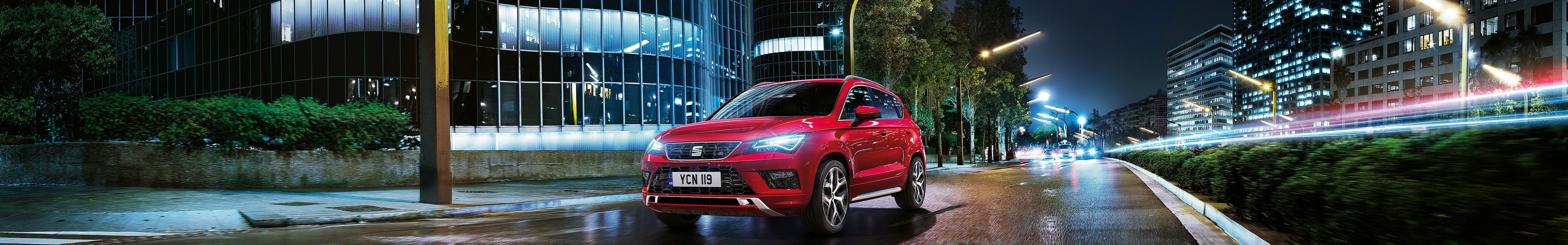 A red SEAT Ateca FR on a road