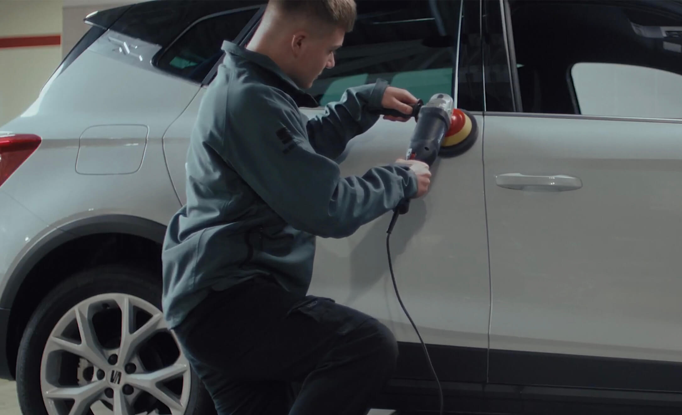 A worker fixing a car door